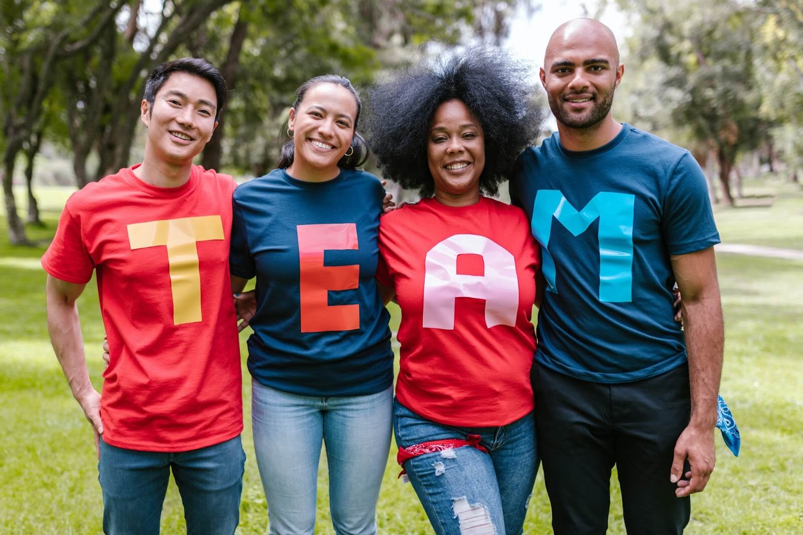 Group of people wearing t-shirts that spell the word 'team'